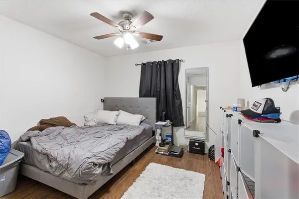 a bed room with a bed and a flat screen tv
