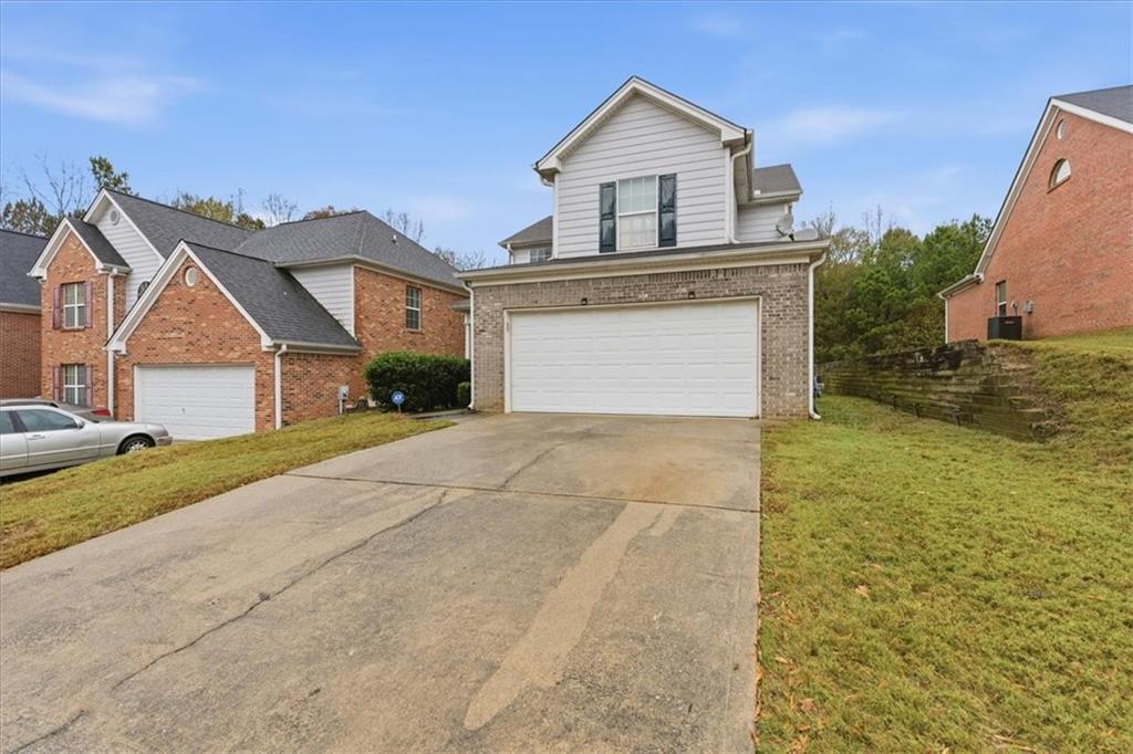 809 Winsap Drive Stockbridge, GA 30281 - Photo 4 of 41 a front view of a house with a yard and garage