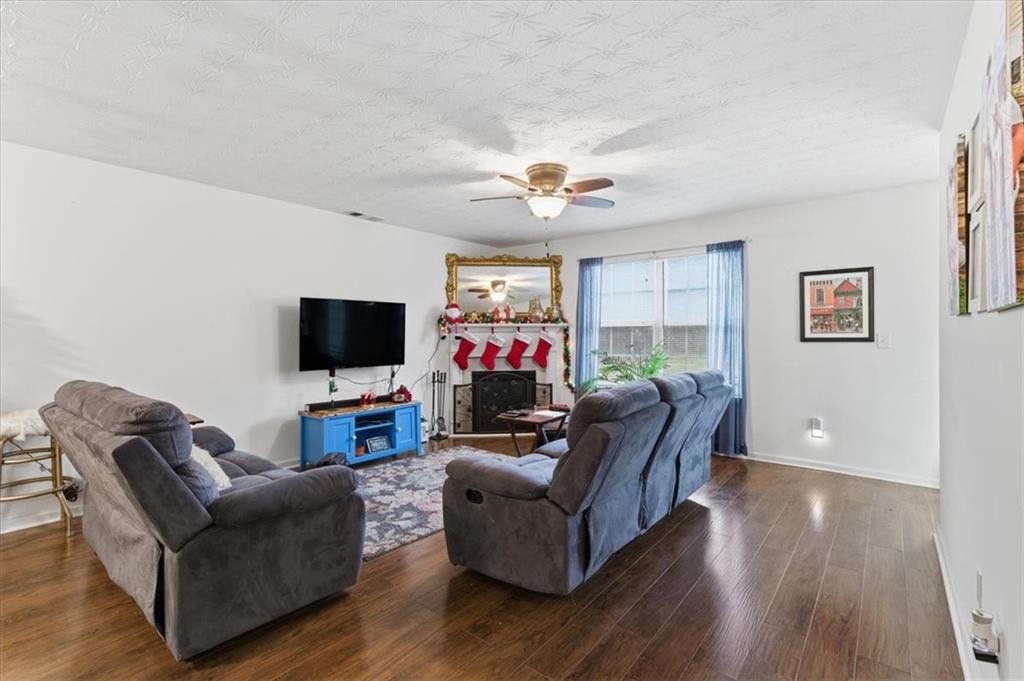 809 Winsap Drive Stockbridge, GA 30281 - Photo 8 of 41 a living room with furniture and a flat screen tv