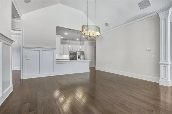 a view of a kitchen with wooden floor and a kitchen