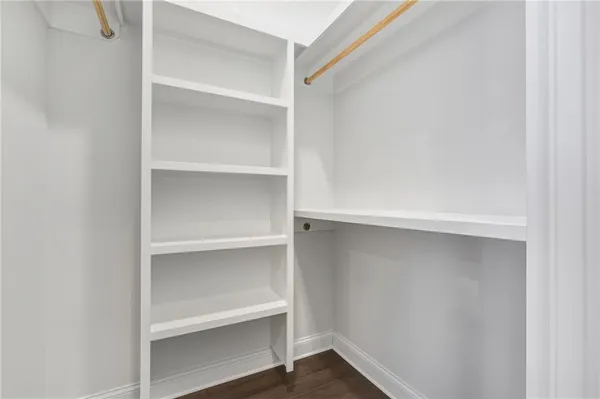 a view of walk in closet with empty racks