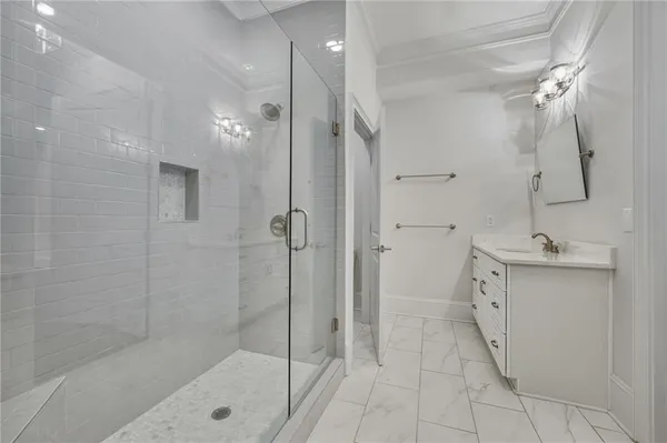 a bathroom with a double vanity sink a toilet and shower