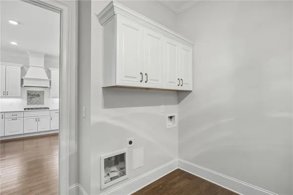 a view of kitchen with wooden floor and cabinets
