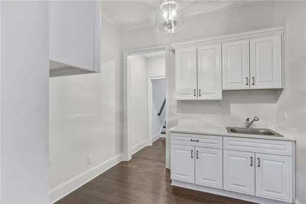 a kitchen with stainless steel appliances granite countertop white cabinets and a sink