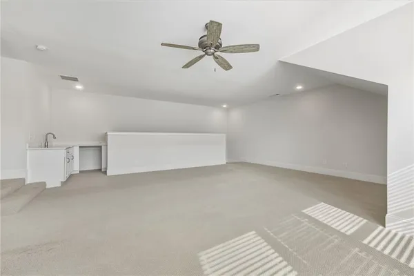 a view of empty room with ceiling fan