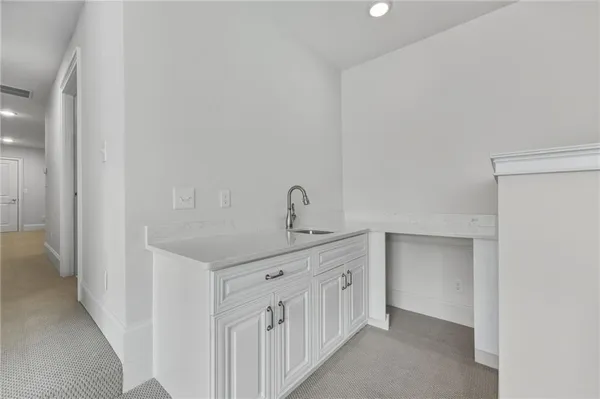 a hallway with two sink and a mirror