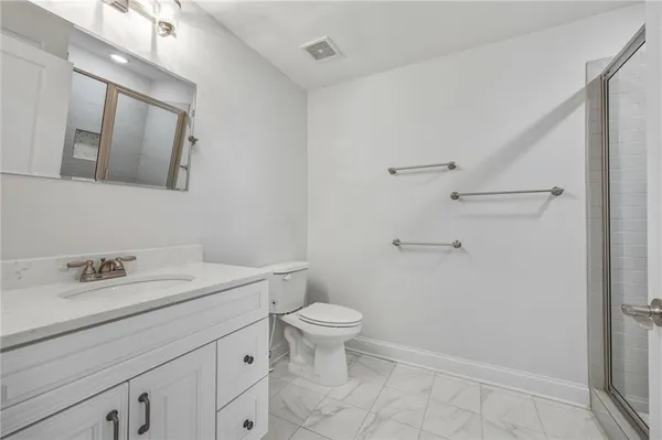 a bathroom with a sink a toilet and a mirror