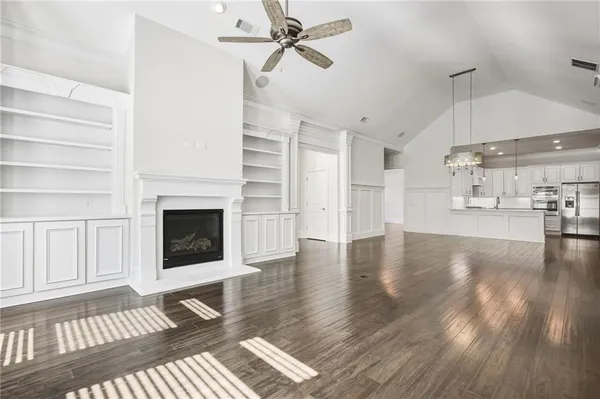 a view of a livingroom with wooden floor and a fireplace