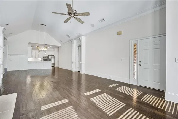 a view of empty room with wooden floor