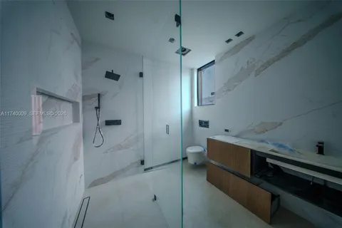 a bathroom with a glass shower door