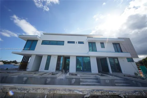 a view of a brick house with large windows