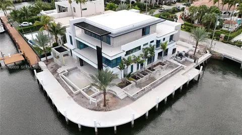 a view of a house with pool and chairs