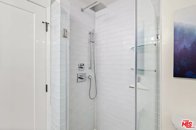 a spacious bedroom with a bed and large windows