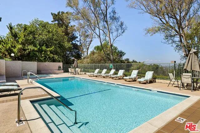 a view of a swimming pool with chairs