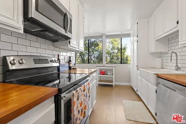 a kitchen that has a sink and a stove