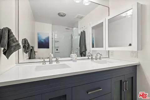 a bathroom with a glass shower door
