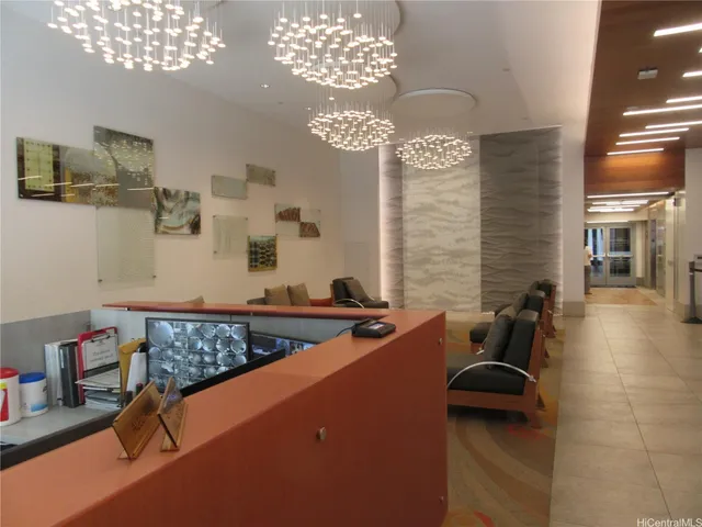 a living room with furniture a chandelier and a large mirror
