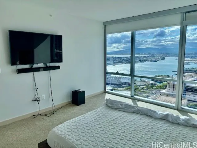 a room with a large window and a bed