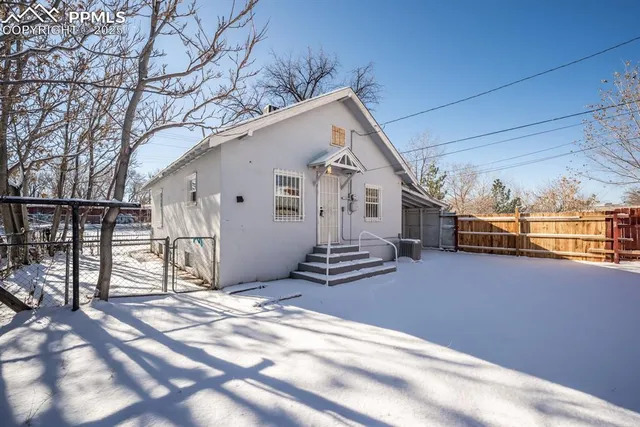 a view of a house with a snow in the yard