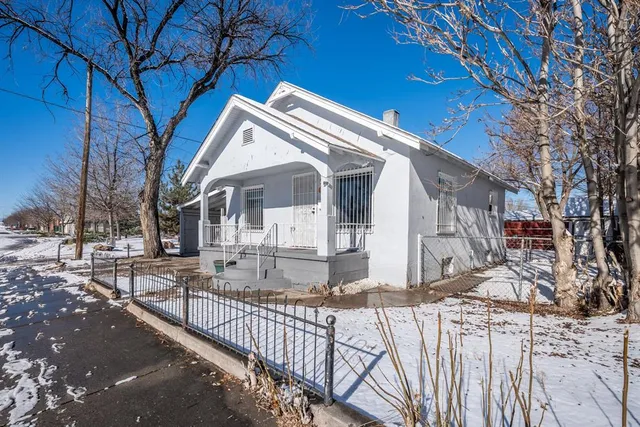 a view of a house with wooden fence
