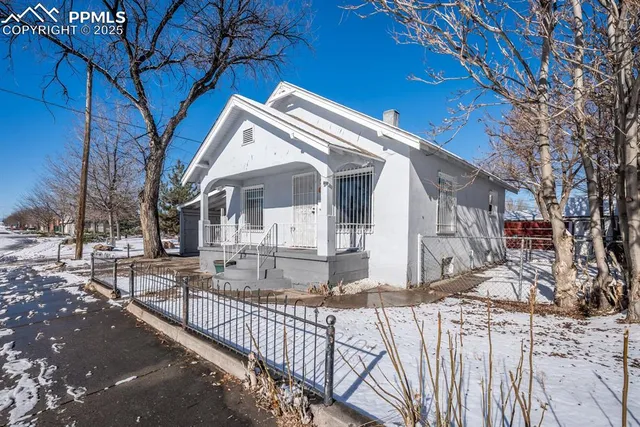 a view of a house with wooden fence