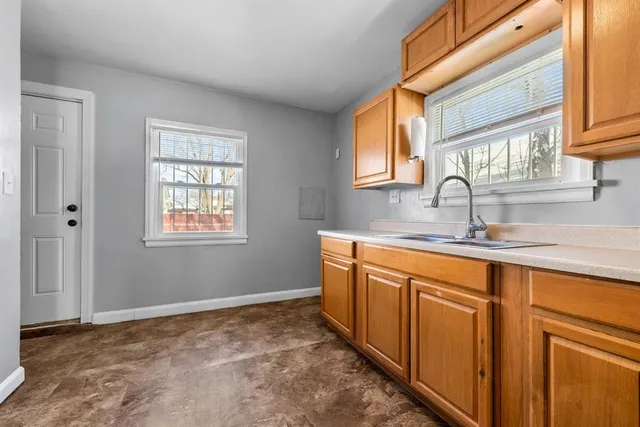 a kitchen with stainless steel appliances granite countertop a sink and a window