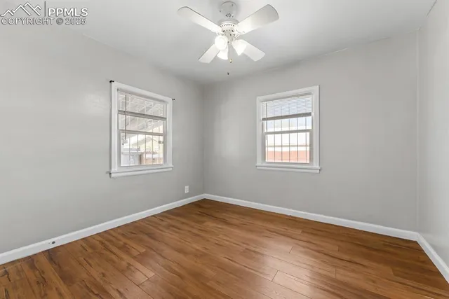 a view of a room with wooden floor and a window