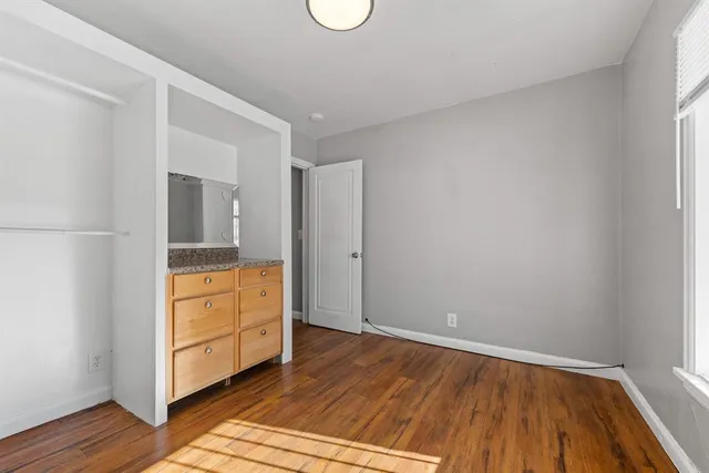 a view of room with wooden floor
