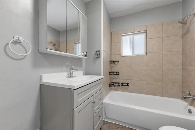 a bathroom with a sink a toilet and bathtub