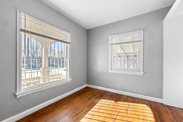 a view of a room with wooden floor and a window
