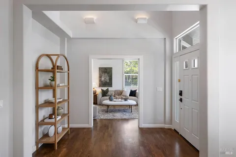 a view of a livingroom with wooden floor and furniture