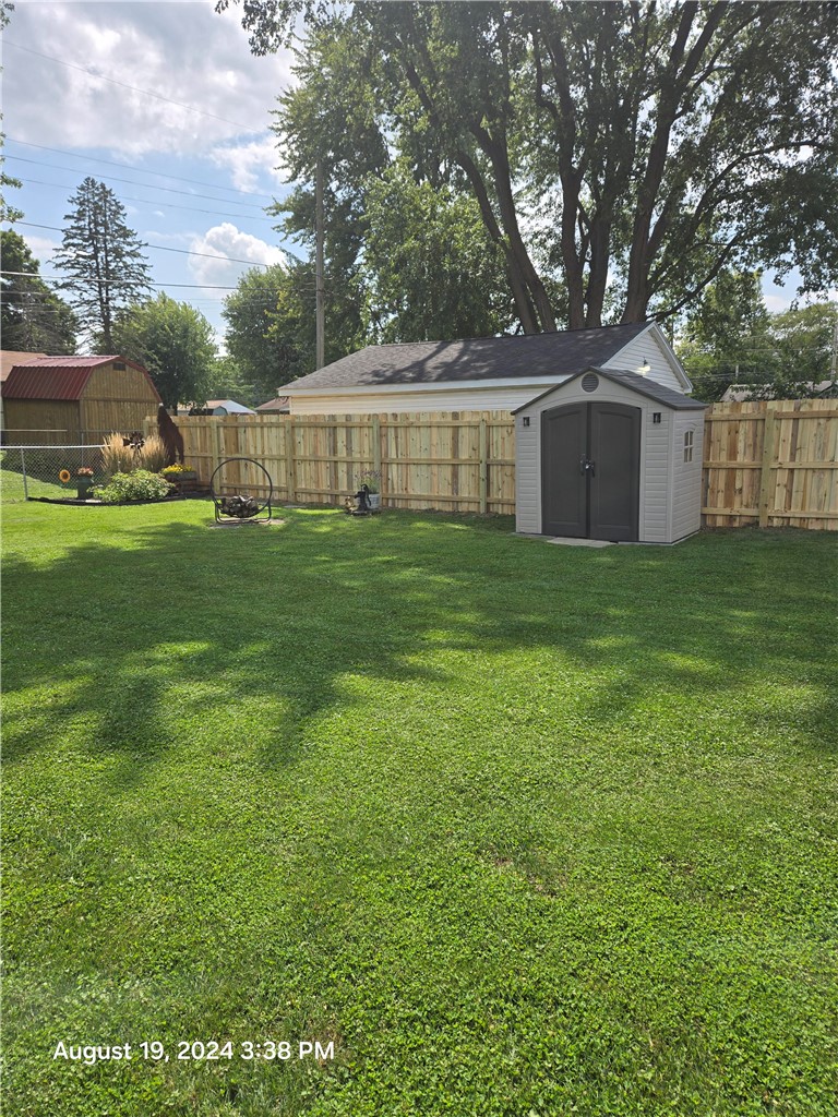 321 Liberty Street Eaton, OH 45320 - Photo 12 of 34 A spacious backyard with mature trees offers a private oasis for outdoor enjoyment.