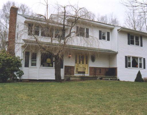 75 Beaver Brook Road Ridgefield, CT 06877 - Photo 1 of 1 a front view of a house with a yard