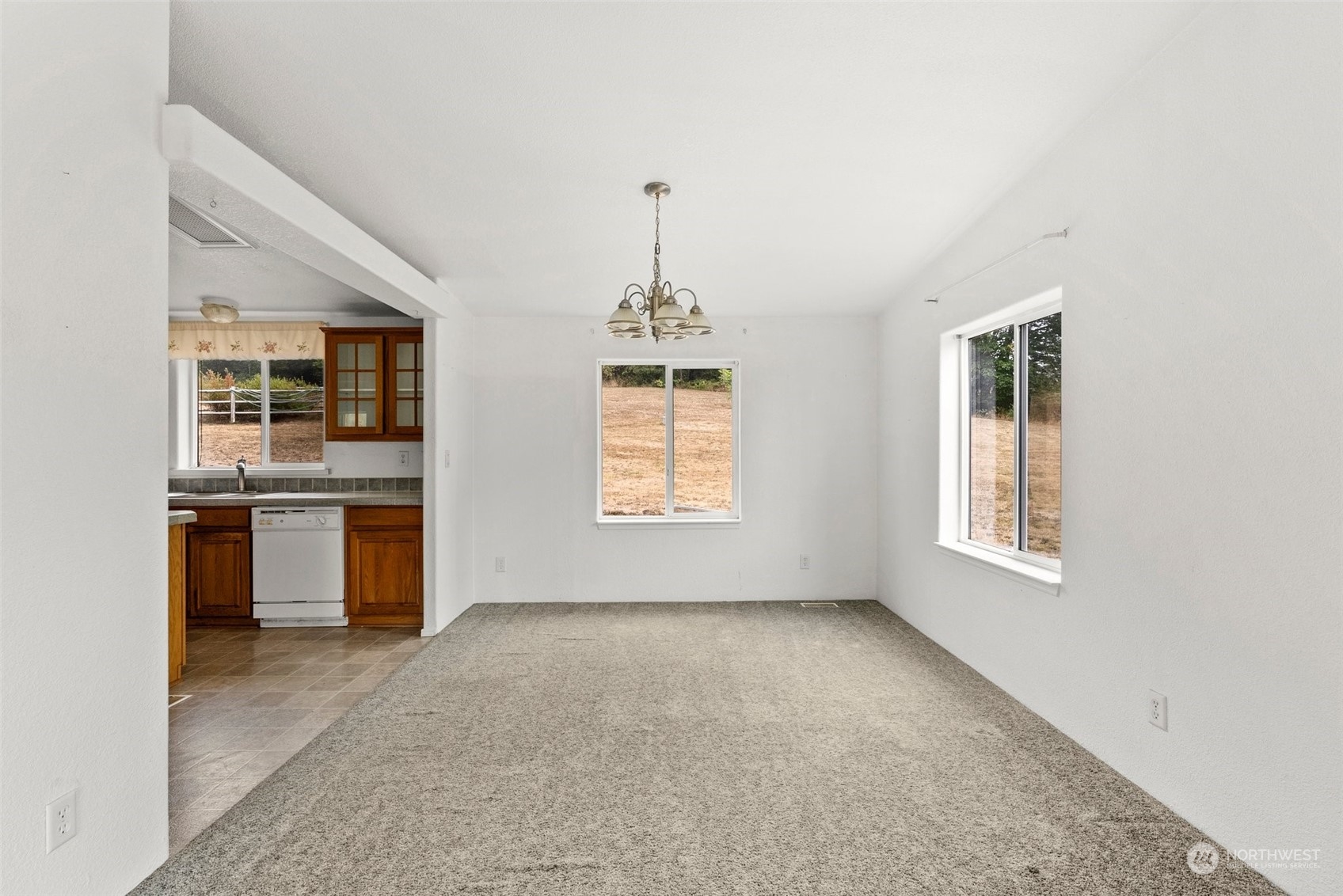 144 Aumick Road Winlock, WA 98596 - Photo 11 of 35 a view of an empty room with kitchen and window