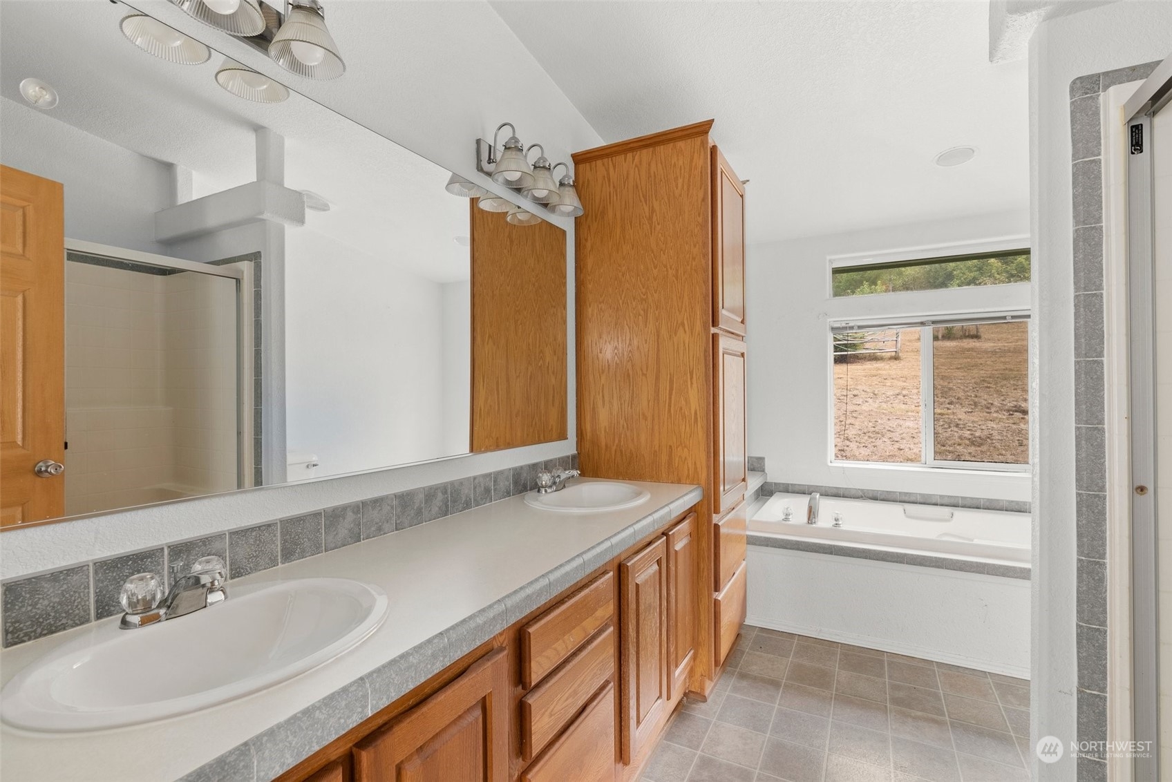 144 Aumick Road Winlock, WA 98596 - Photo 14 of 35 a bathroom with a granite countertop sink and a mirror
