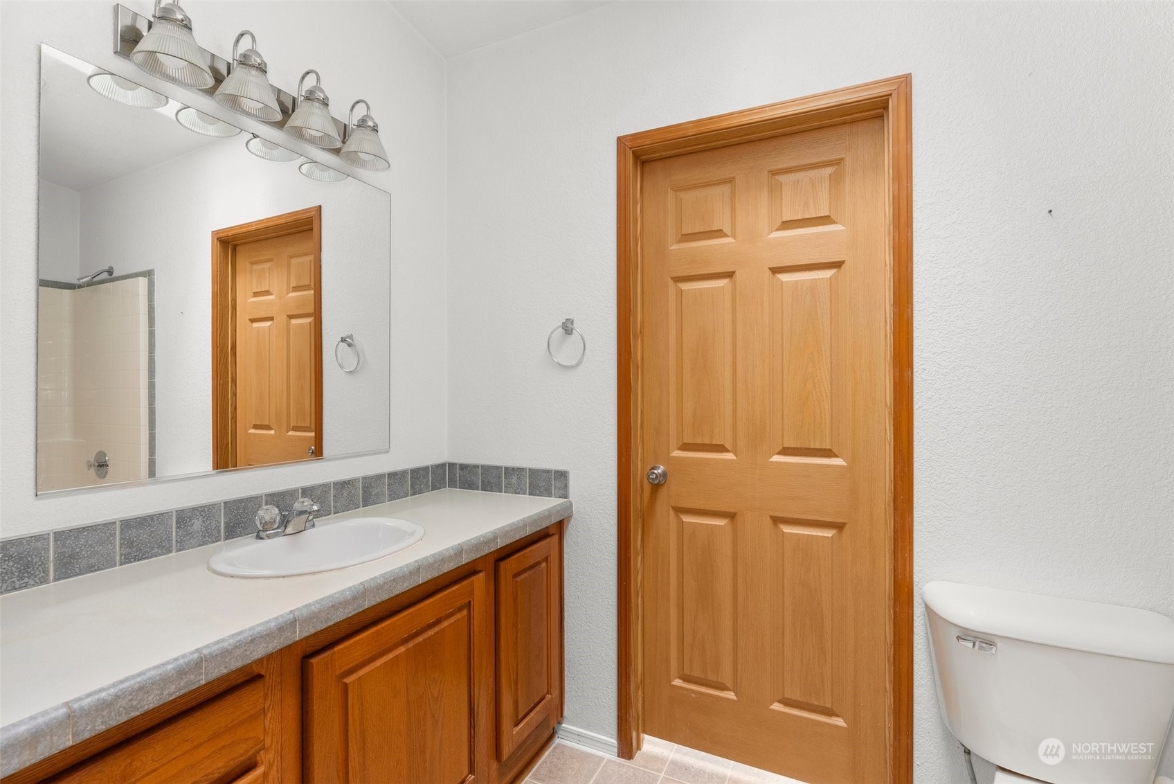 144 Aumick Road Winlock, WA 98596 - Photo 18 of 35 a bathroom with a sink vanity granite and a mirror