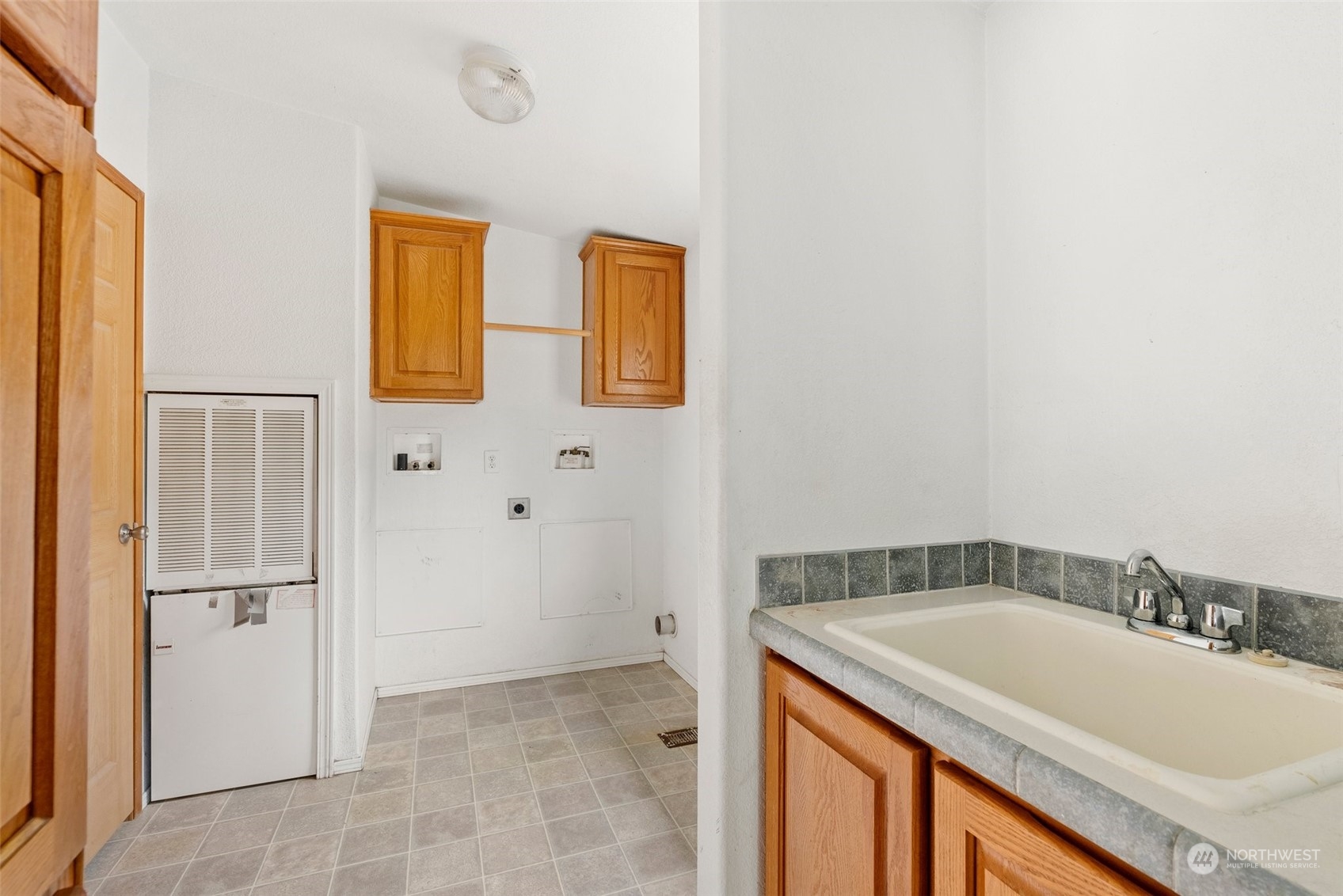 144 Aumick Road Winlock, WA 98596 - Photo 20 of 35 a bathroom with a granite countertop sink and washing machine