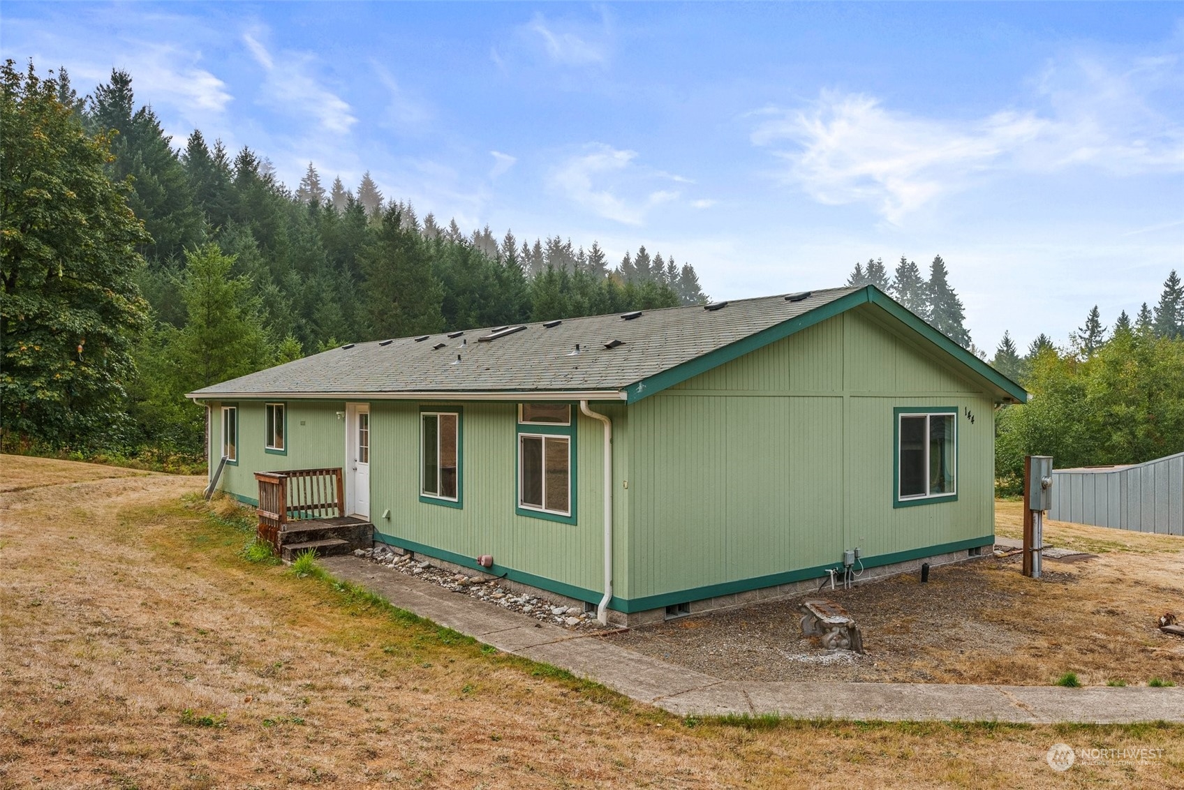 144 Aumick Road Winlock, WA 98596 - Photo 21 of 35 a view of a house with a backyard and trees