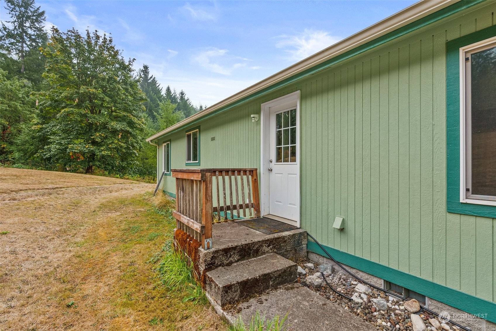 144 Aumick Road Winlock, WA 98596 - Photo 22 of 35 a view of a house with a small yard and wooden fence