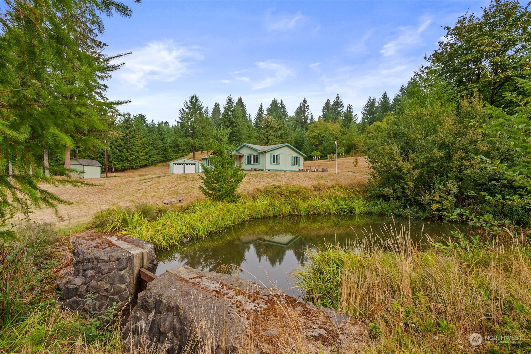 144 Aumick Road Winlock, WA 98596 - Photo 24 of 35 a view of a lake with houses in the back