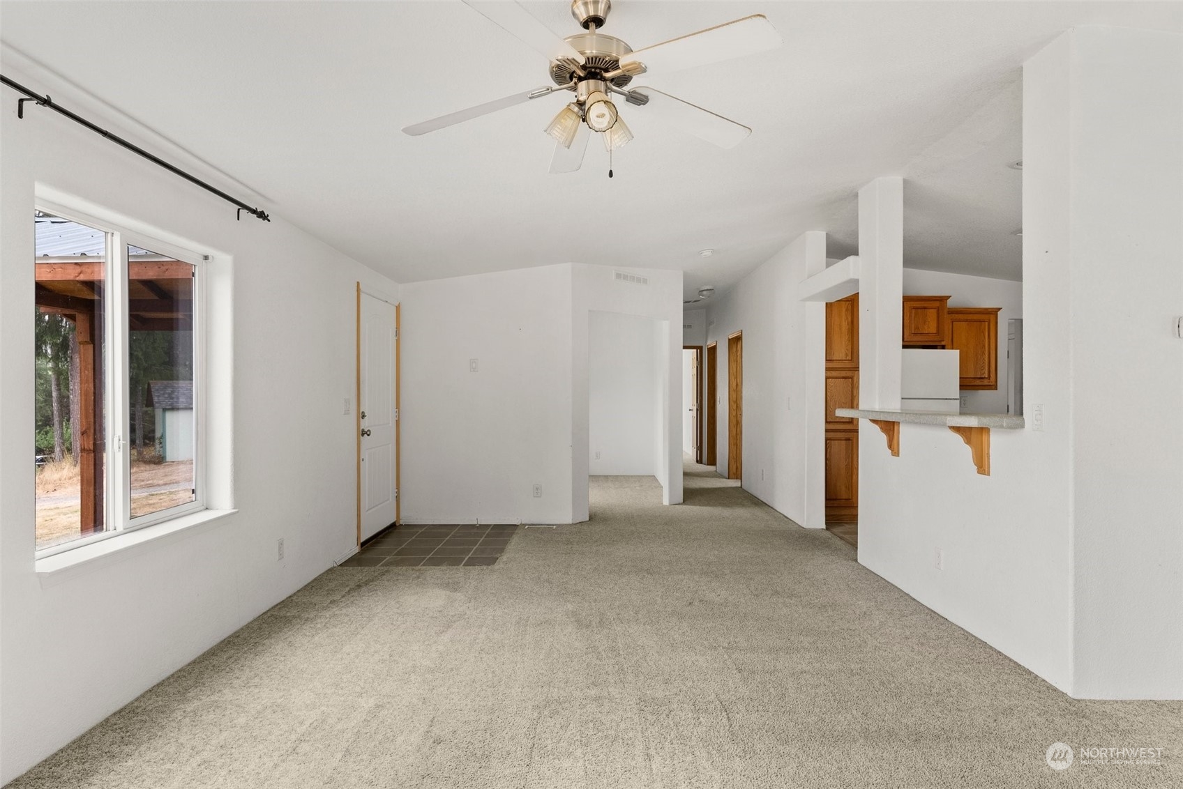144 Aumick Road Winlock, WA 98596 - Photo 7 of 35 a view of a big room with windows and ceiling fan