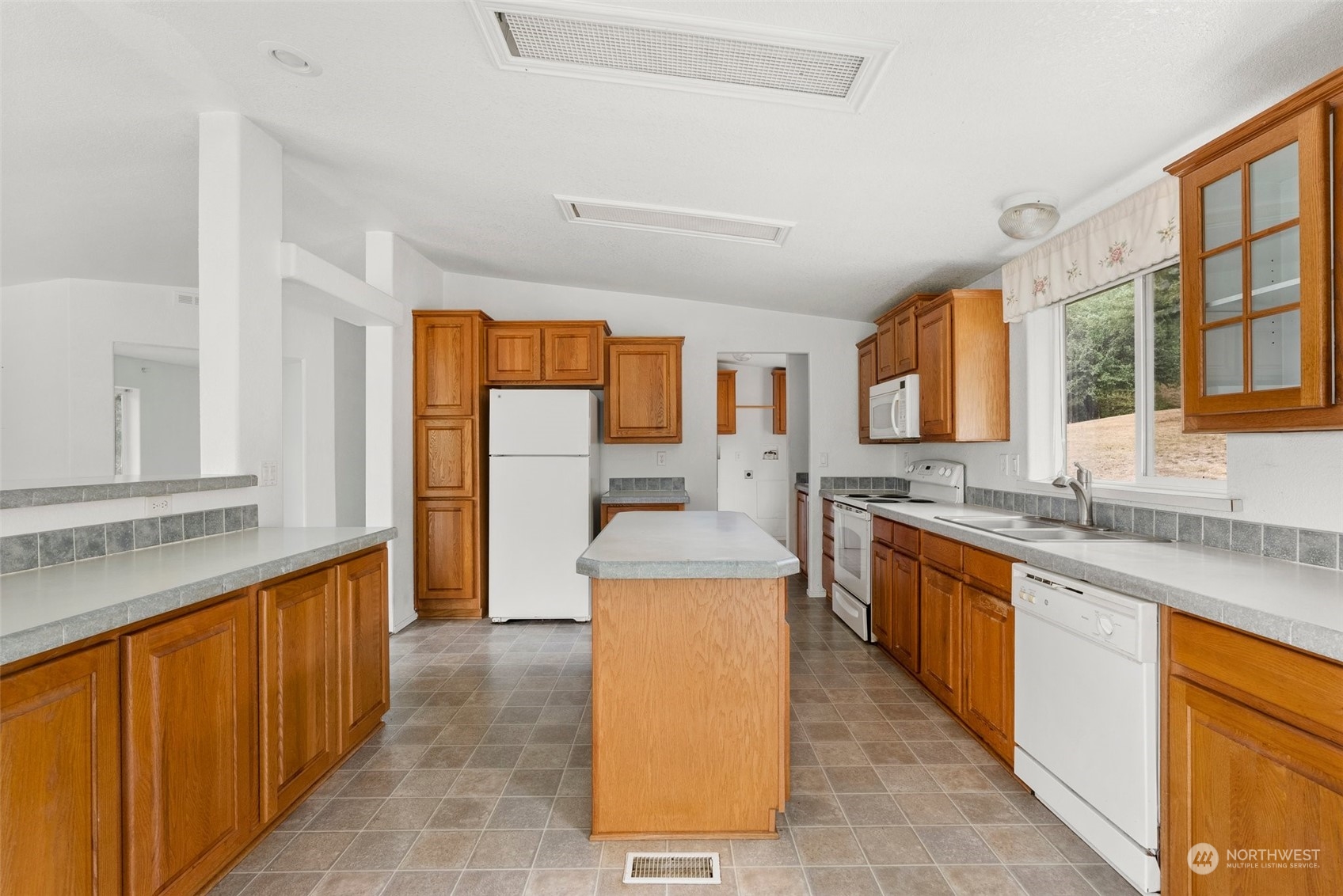 144 Aumick Road Winlock, WA 98596 - Photo 8 of 35 a large kitchen with stainless steel appliances granite countertop wooden cabinets a sink and a stove