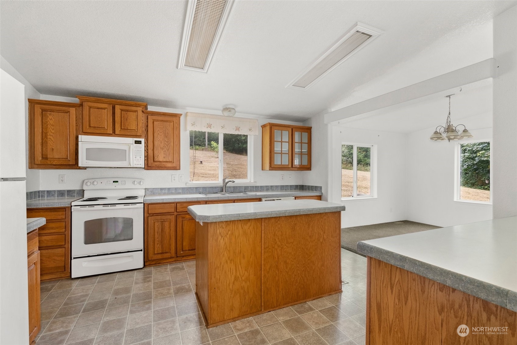 144 Aumick Road Winlock, WA 98596 - Photo 9 of 35 a kitchen with stainless steel appliances granite countertop a stove a sink and a refrigerator