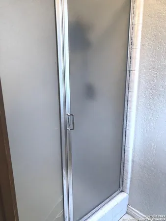 a bathroom with a glass shower door