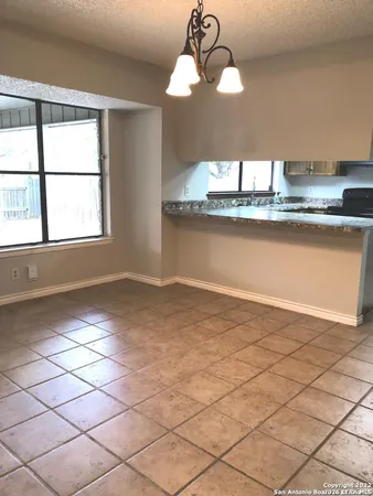 a view of a room with wooden floor and a window