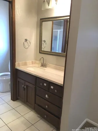 a bathroom with a sink vanity and mirror