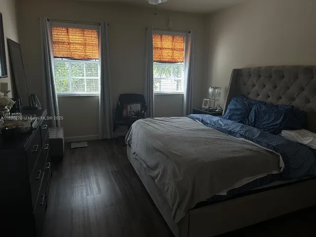 a bed sitting in a bedroom next to a window