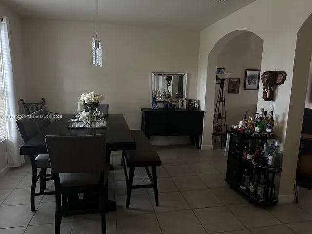 a dining room with furniture and window