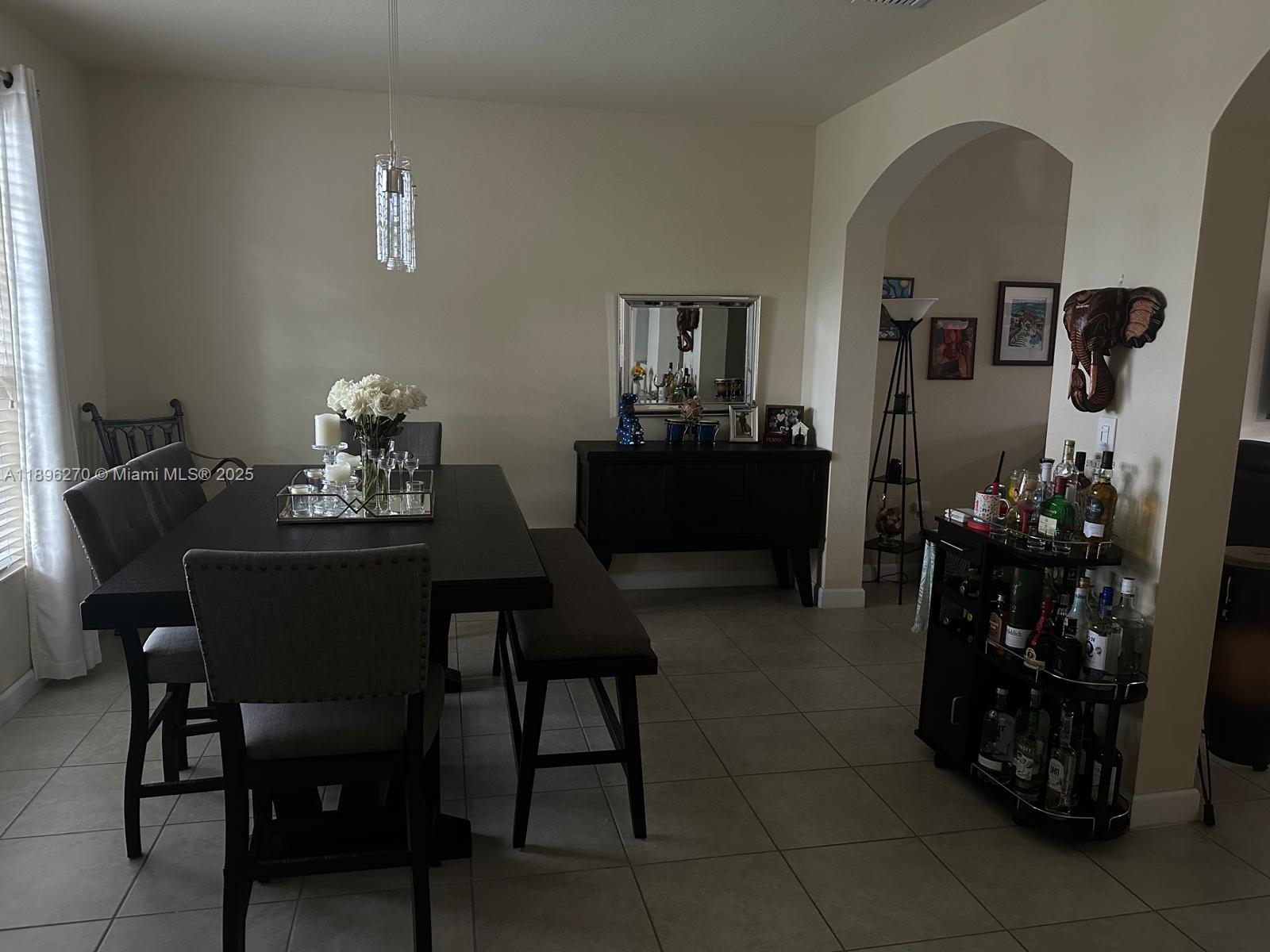 17135 Southwest 96th Street Miami, FL 33196 - Photo 3 of 34 a dining room with furniture and window