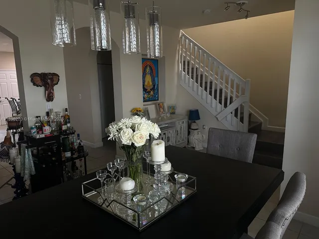 a dining room with furniture and wooden floor